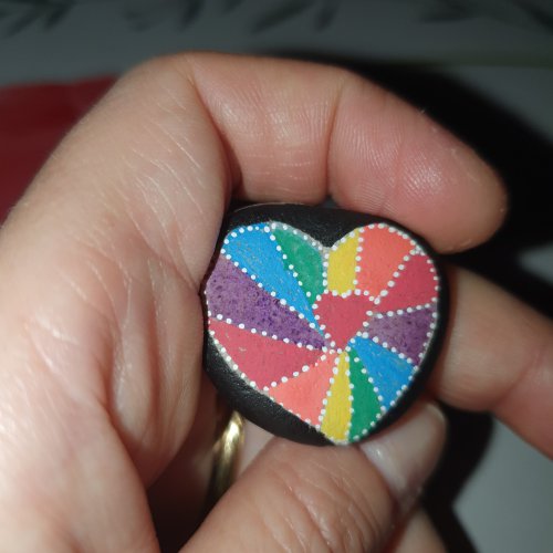 Multicolored heart on pebble